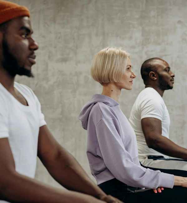 Diverse group of people feeling relaxed and happy after a yoga session.